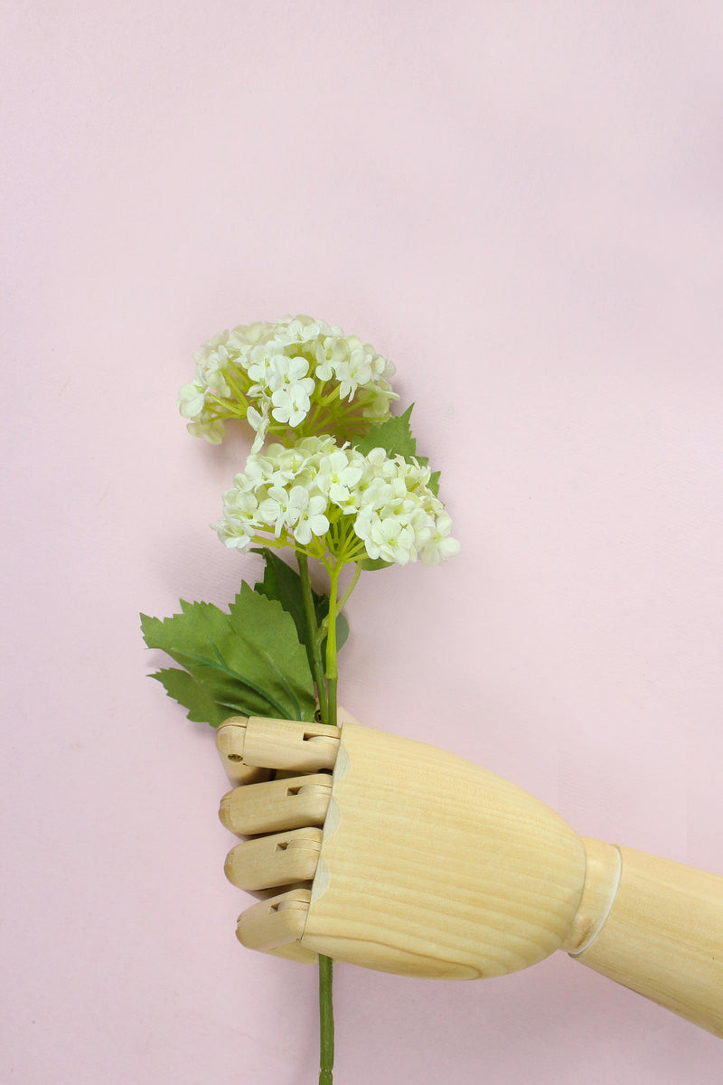 mano maniquí madera cogiendo flor