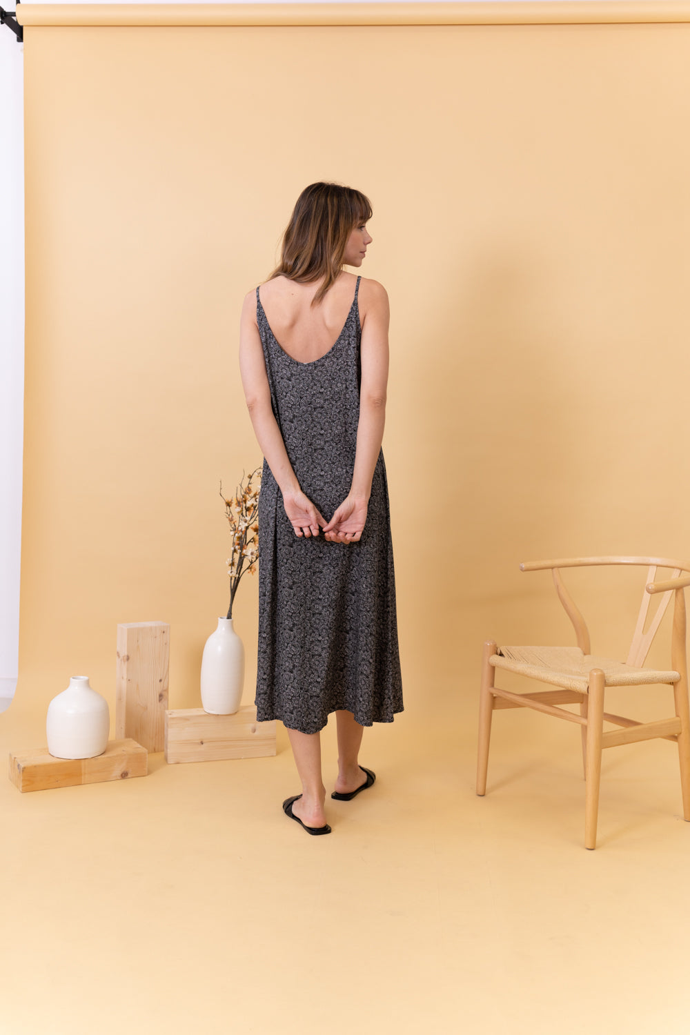 MODELO CON VESTIDO NEGRO ESTAMPADO DE ESPALDA