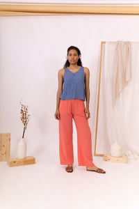 MUJER DE FRENTE CON PANTALÓN CORAL Y TOP AZUL